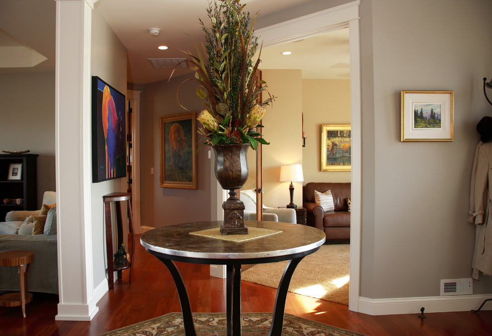 Foyer - mid-sized transitional dark wood floor and brown floor foyer idea in Seattle with gray walls and a dark wood front door