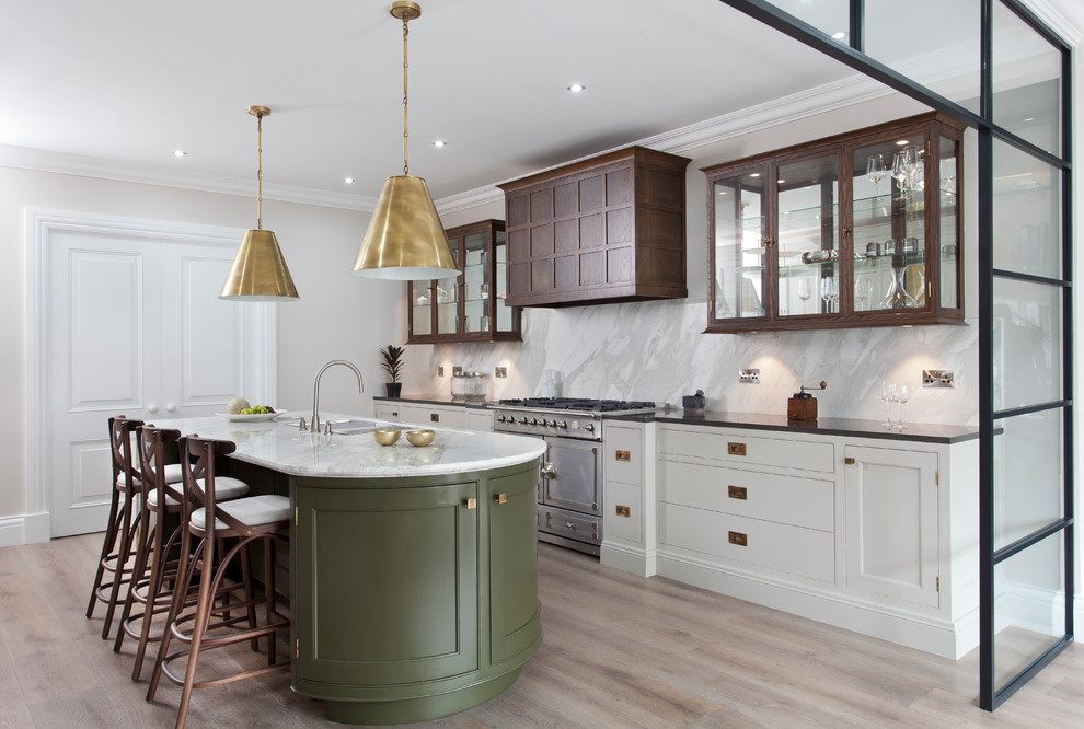 Transitional kitchen in West Midlands with a double-bowl sink, glass-front cabinets, dark wood cabinets, white splashback, marble splashback, stainless steel appliances, light hardwood floors, with island and beige floor.