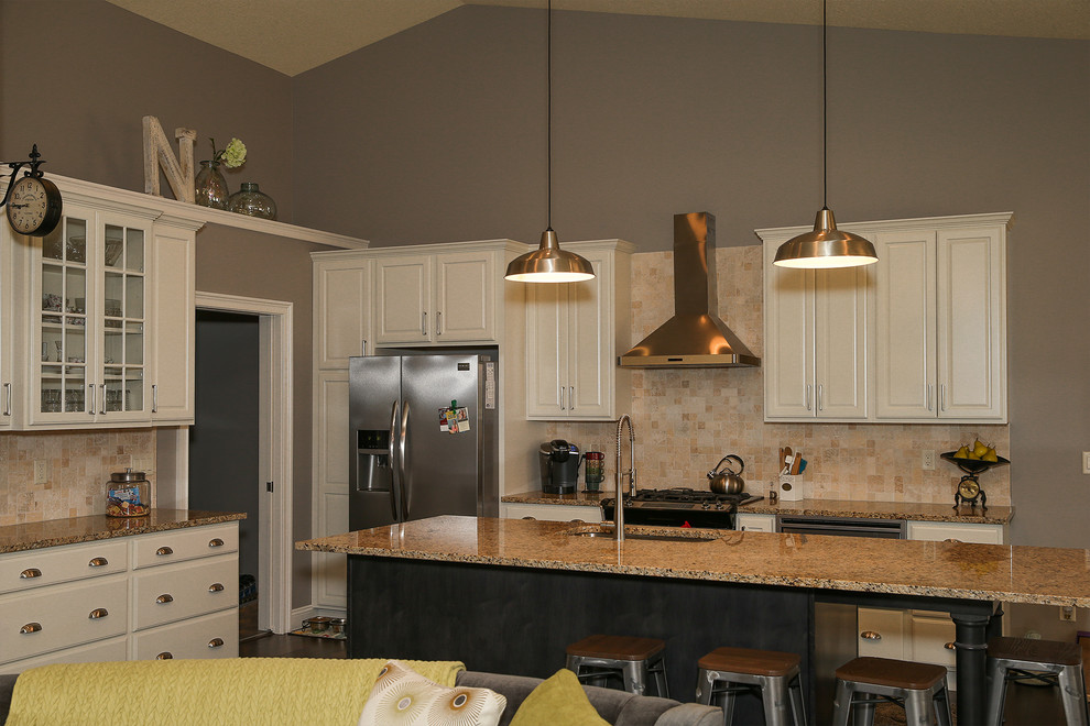 Mid-sized transitional l-shaped dark wood floor and brown floor open concept kitchen photo in Chicago with an undermount sink, raised-panel cabinets, white cabinets, granite countertops, beige backsplash, stone tile backsplash, stainless steel appliances and an island