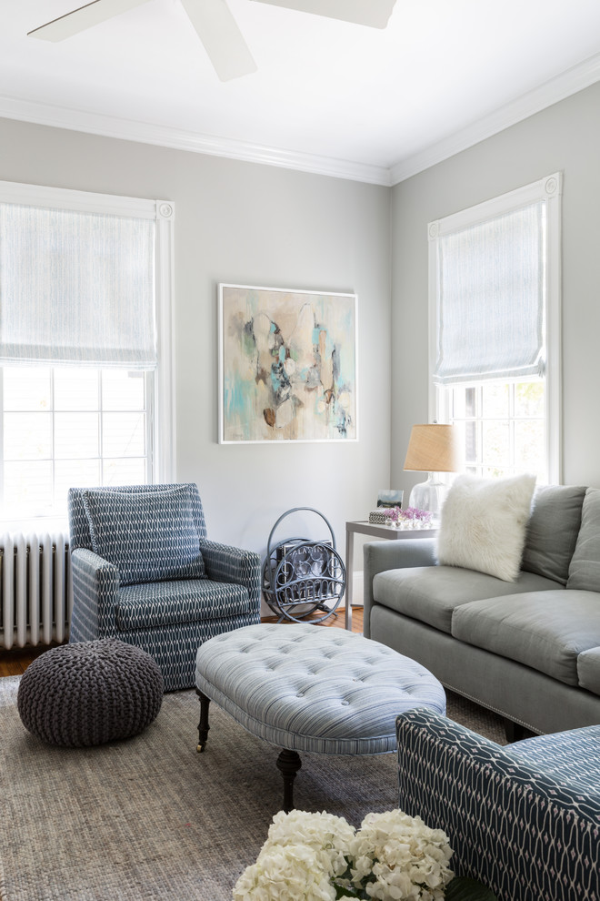 This is an example of a mid-sized transitional formal enclosed living room in DC Metro with grey walls, medium hardwood floors, no fireplace and no tv.