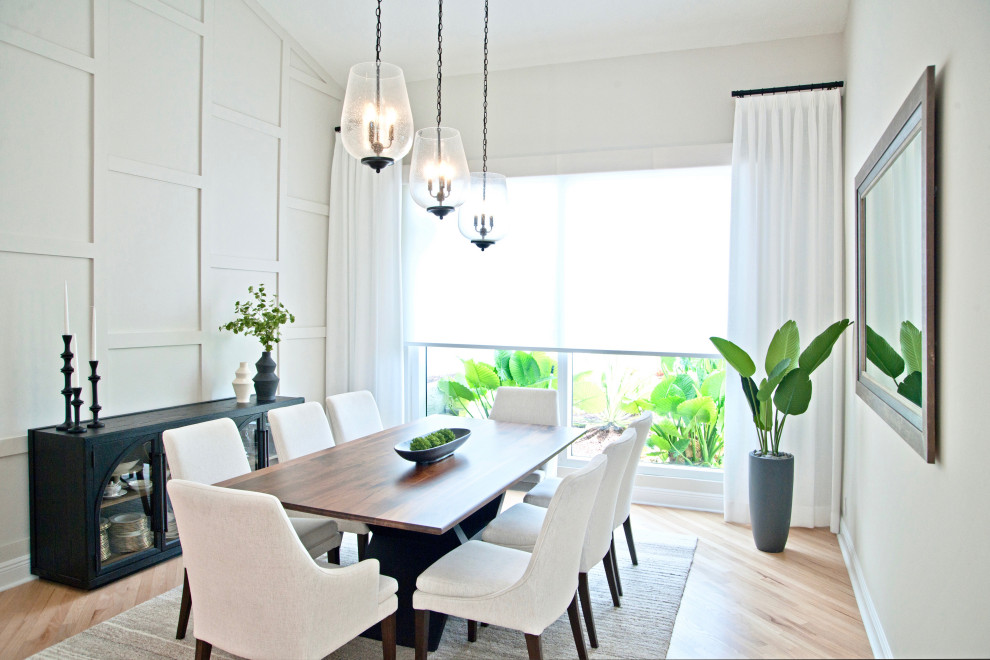 Mid-sized transitional open plan dining in Miami with grey walls, light hardwood floors, beige floor, vaulted and wood walls.
