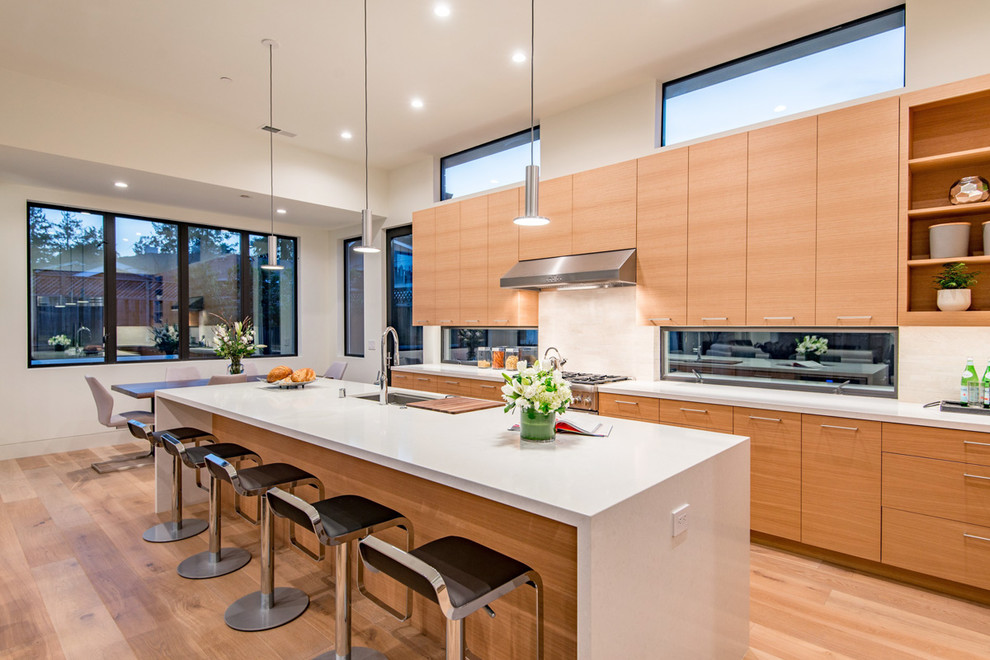 Design ideas for a contemporary eat-in kitchen in San Francisco with an undermount sink, flat-panel cabinets, light wood cabinets, beige splashback, light hardwood floors and with island.