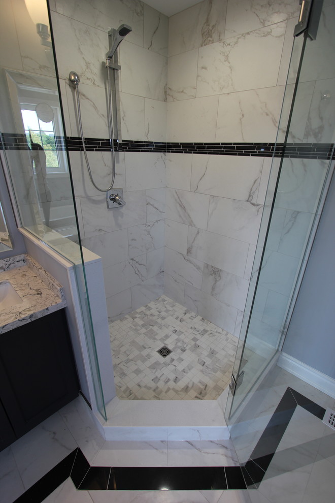 Inspiration for a mid-sized contemporary master bathroom in Toronto with shaker cabinets, dark wood cabinets, a freestanding tub, a corner shower, a two-piece toilet, white tile, porcelain tile, grey walls, porcelain floors, an undermount sink, quartzite benchtops, white floor and a hinged shower door.