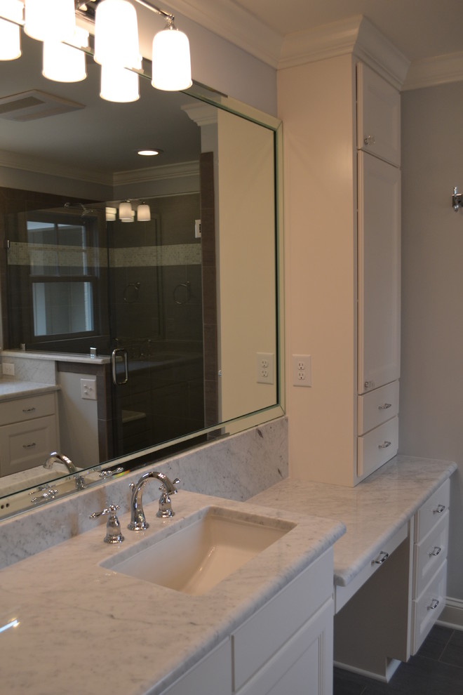 Traditional bathroom in Raleigh with recessed-panel cabinets, white cabinets, a double shower, gray tile, porcelain tile, ceramic floors, an undermount sink and marble benchtops.