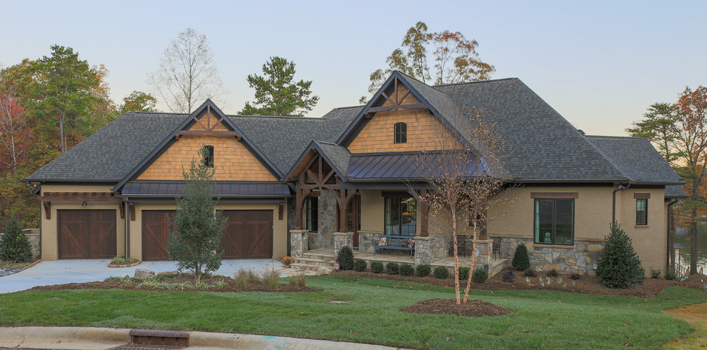 Design ideas for a large country two-storey stucco beige exterior in Charlotte with a hip roof.