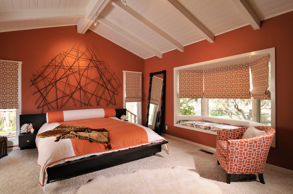 Design ideas for a large transitional master bedroom in Other with orange walls, carpet and timber.