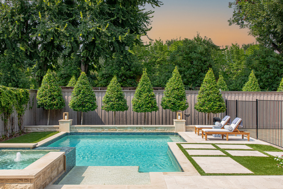 This is an example of a transitional backyard custom-shaped pool in Dallas with a hot tub and concrete pavers.