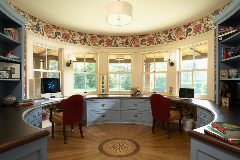This is an example of a traditional home office in Minneapolis with a built-in desk.