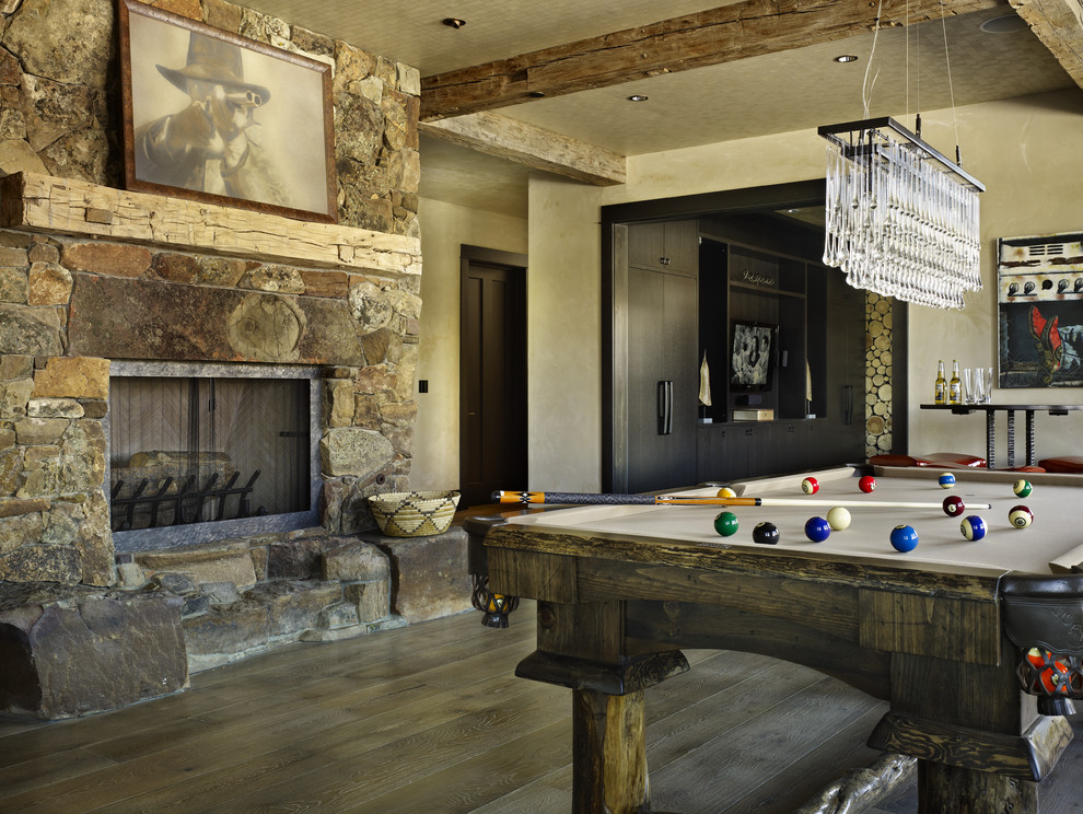 Inspiration for a country family room in Denver with beige walls, a standard fireplace and a stone fireplace surround.