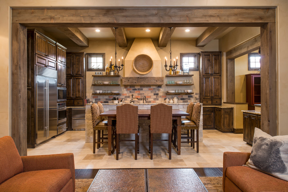 Kitchen - rustic u-shaped beige floor kitchen idea in Austin with raised-panel cabinets, dark wood cabinets, multicolored backsplash, stainless steel appliances and an island
