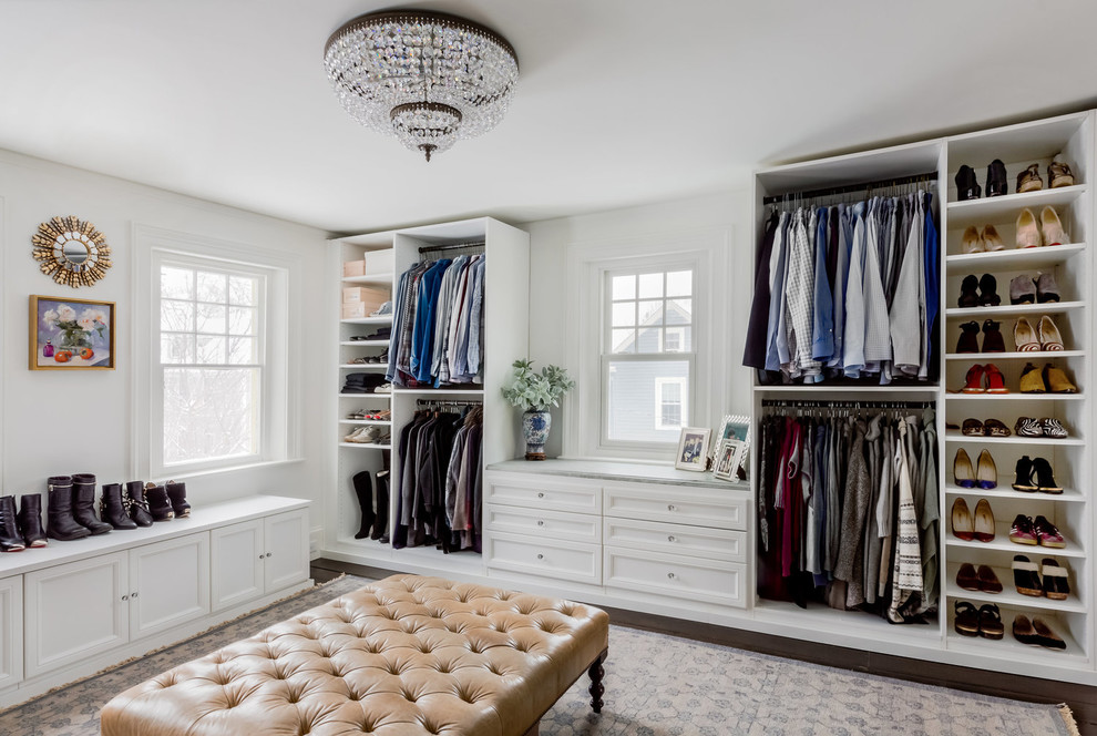 Photo of a transitional women's walk-in wardrobe in Boston with open cabinets, white cabinets, dark hardwood floors and brown floor.