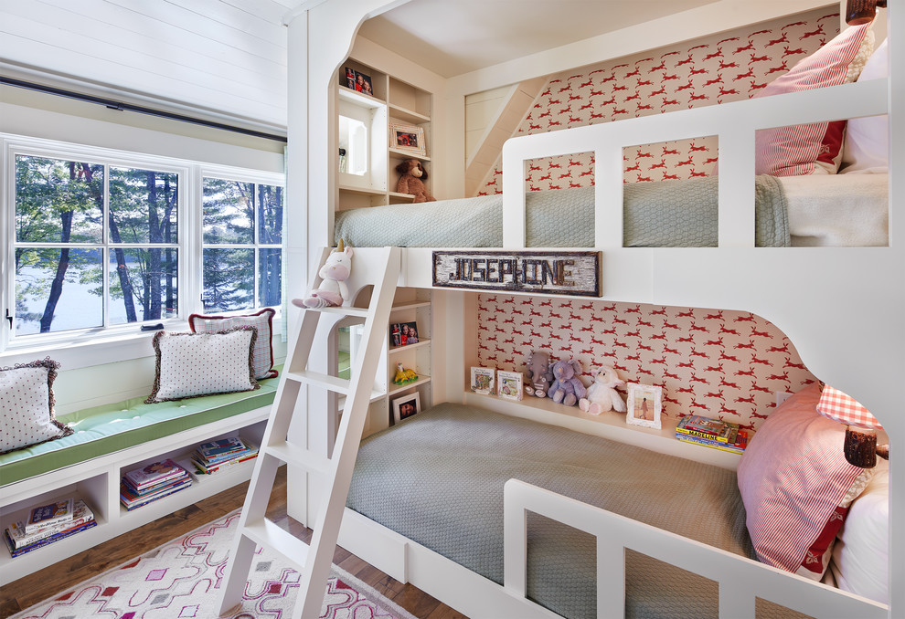 This is an example of a country kids' bedroom for kids 4-10 years old and girls in Minneapolis with multi-coloured walls and dark hardwood floors.