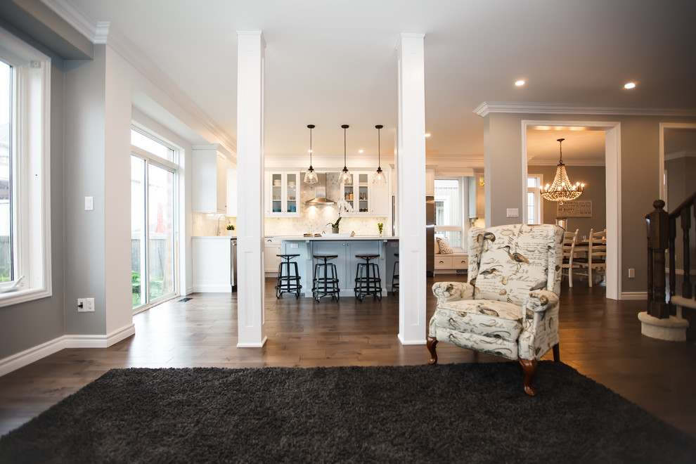Example of a mid-sized transitional galley dark wood floor eat-in kitchen design in Toronto with an undermount sink, shaker cabinets, white cabinets, granite countertops, white backsplash, stone tile backsplash, stainless steel appliances and an island