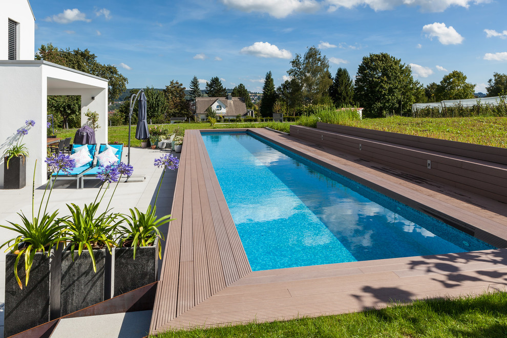 Design ideas for a mid-sized contemporary backyard rectangular lap pool in Stuttgart with decking.