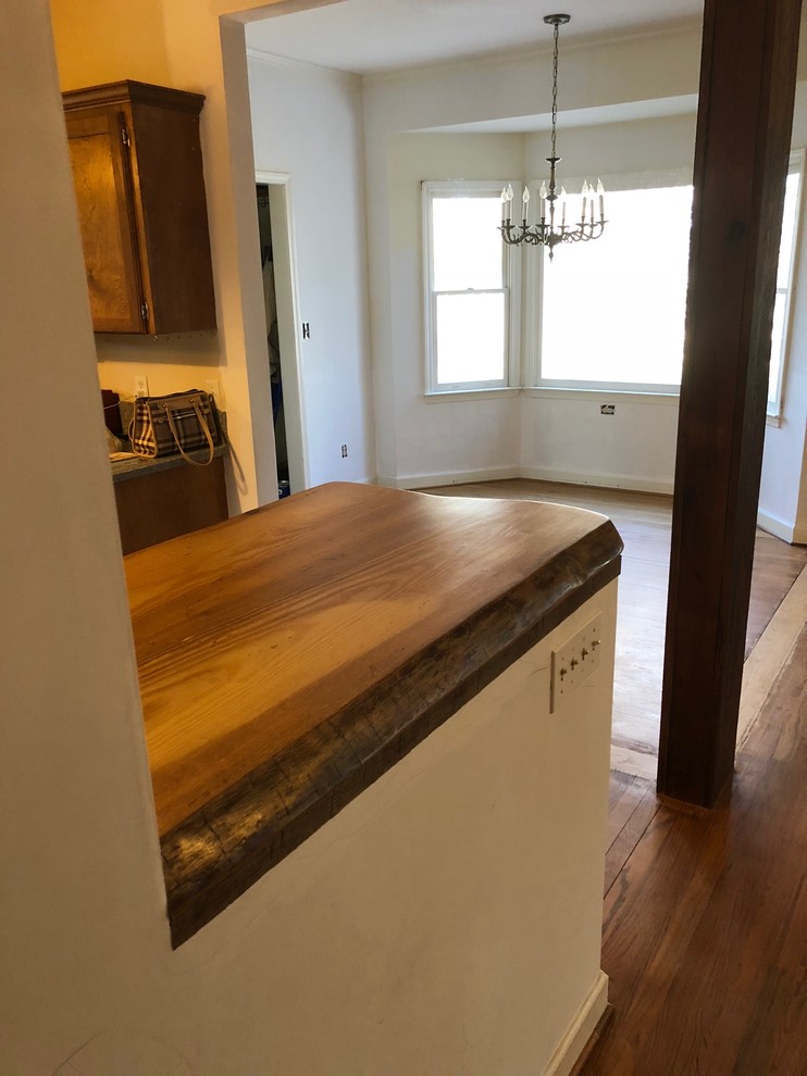 Inspiration for a mid-sized rustic l-shaped home design remodel with wood countertops and brown countertops