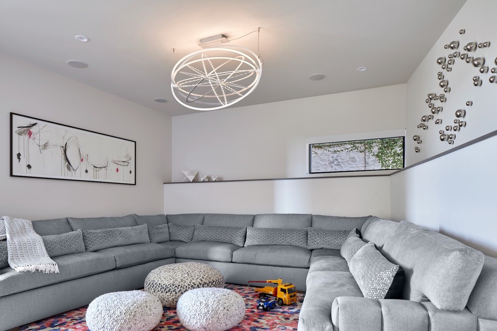 Photo of a contemporary home theatre in Austin with white walls.