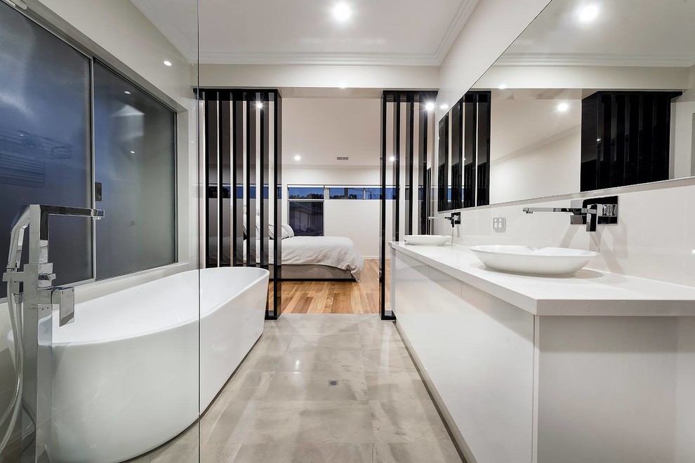 Photo of a modern master bathroom in Perth with white cabinets, a freestanding tub, an open shower, gray tile, porcelain tile, white walls, porcelain floors, a vessel sink and engineered quartz benchtops.
