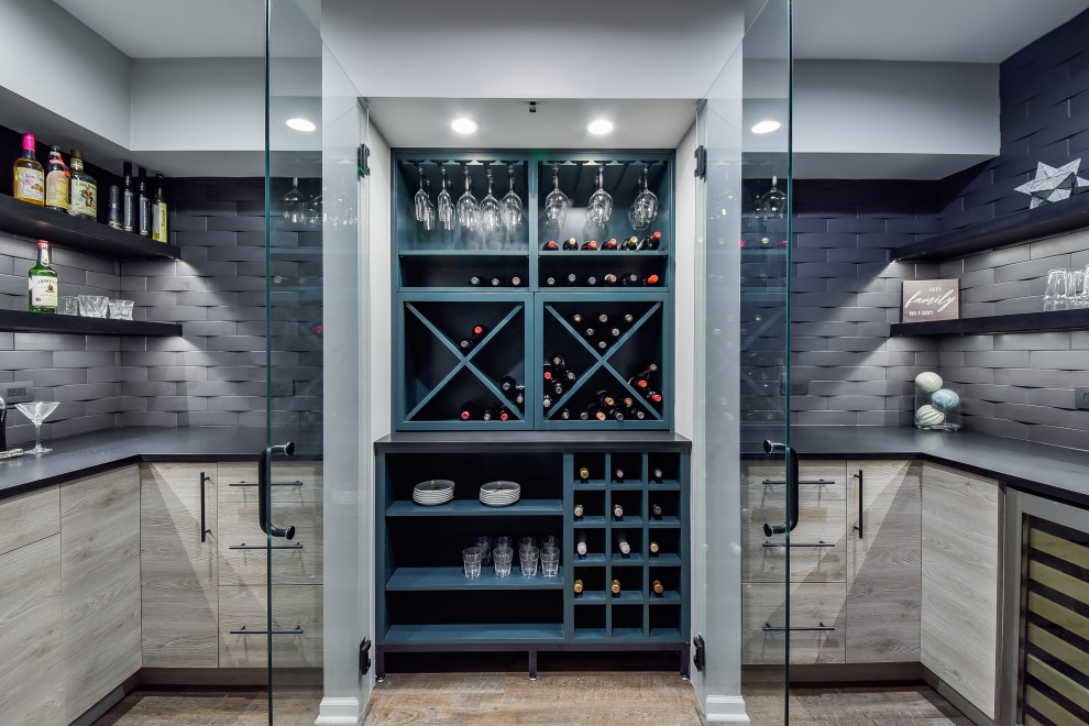 Photo of a contemporary wine cellar in Nashville with diamond bins and brown floor.