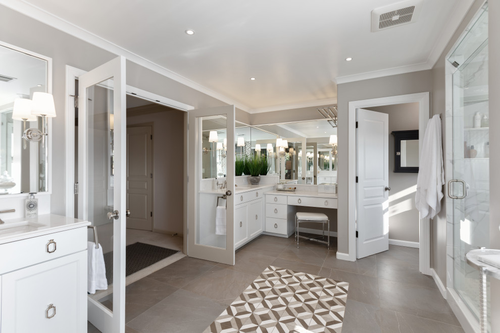 Photo of a large transitional master bathroom in Portland with white cabinets, a freestanding tub, gray tile, grey walls, porcelain floors, an undermount sink, quartzite benchtops, grey floor, white benchtops, an alcove shower, a hinged shower door and recessed-panel cabinets.
