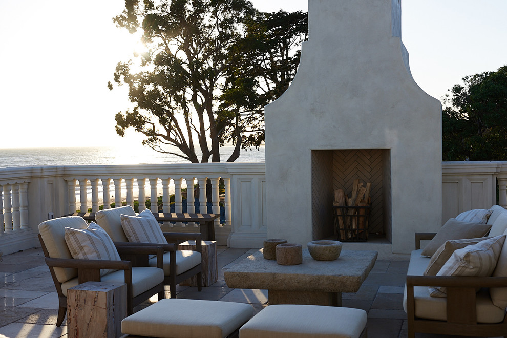 This is an example of a mediterranean balcony in Santa Barbara with with fireplace and no cover.