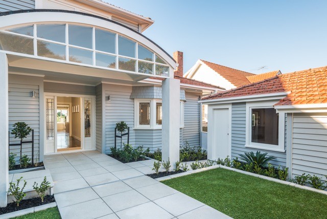 Mid-sized contemporary front yard partial sun formal garden in Auckland with a garden path and natural stone pavers.