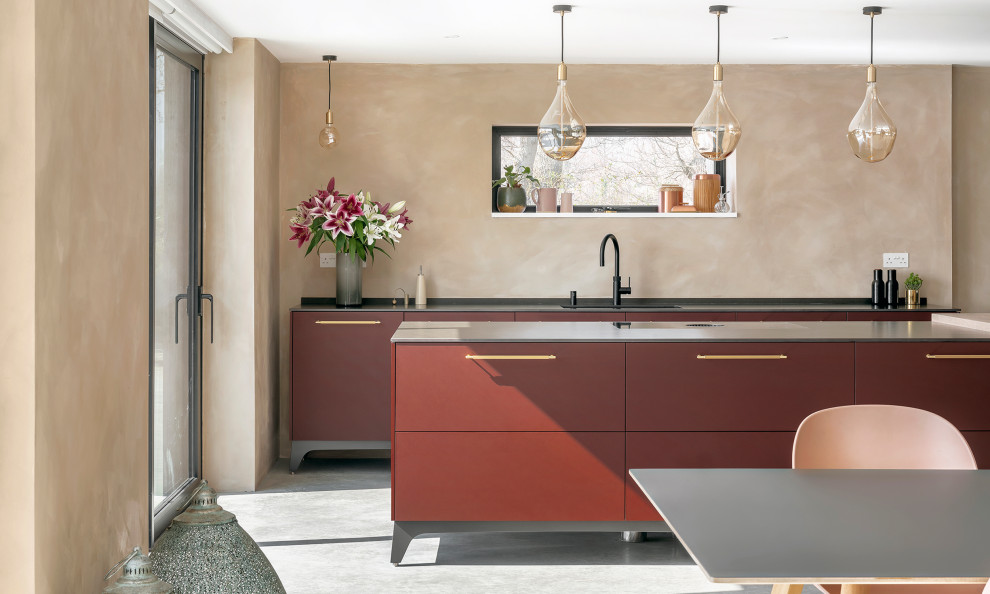 Design ideas for a mid-sized contemporary kitchen in Other with flat-panel cabinets, red cabinets and with island.