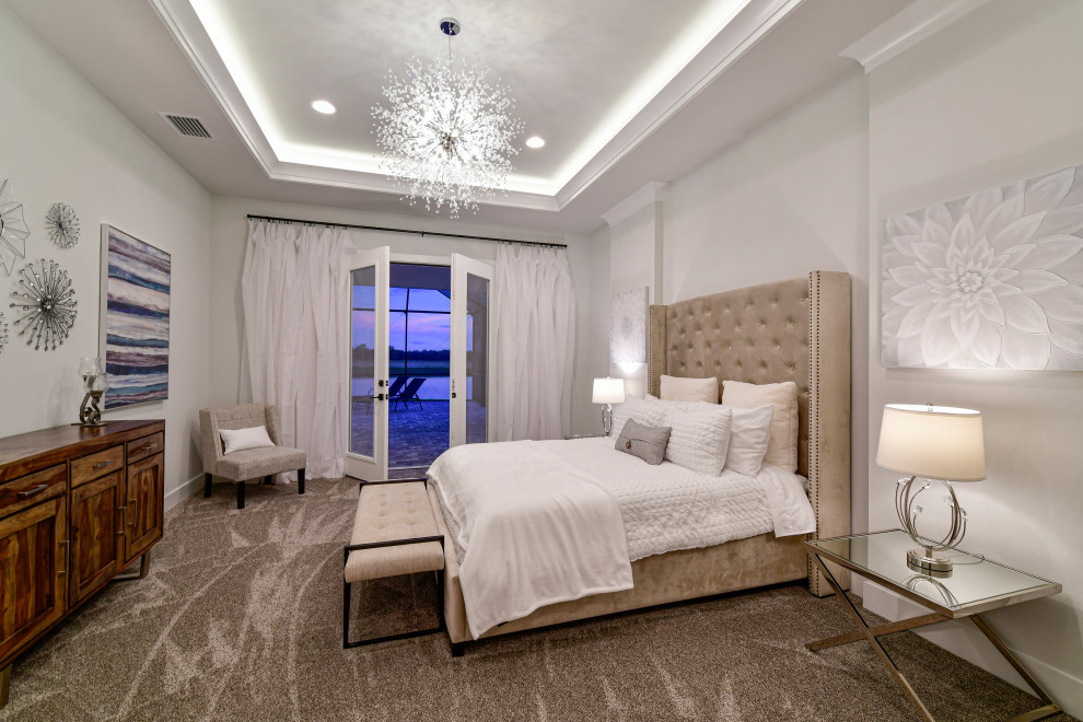 Inspiration for a mid-sized transitional master carpeted, gray floor and tray ceiling bedroom remodel with gray walls