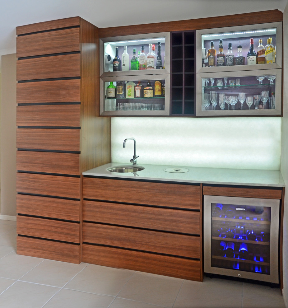 Photo of a mid-sized contemporary galley home bar in Sunshine Coast with an undermount sink, medium wood cabinets, granite benchtops, white splashback, stone slab splashback and porcelain floors.