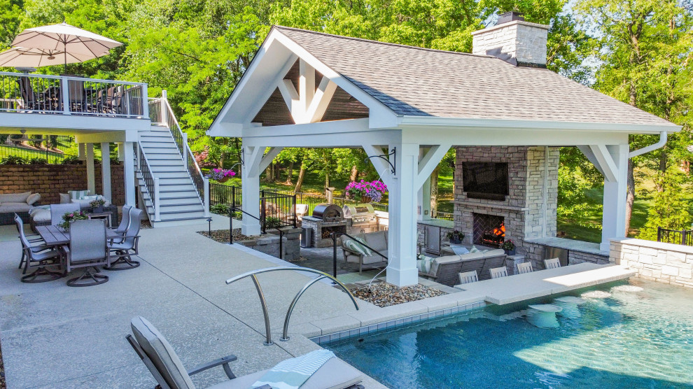 Photo of an expansive traditional backyard patio in St Louis with with fireplace, concrete pavers and a gazebo/cabana.