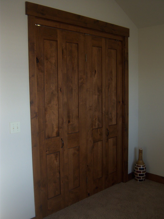 This is an example of a mid-sized arts and crafts front door in Salt Lake City with a dark wood front door, a double front door, white walls and carpet.