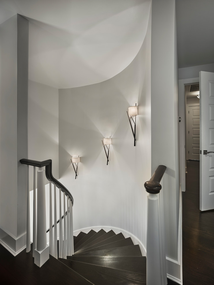 Example of a transitional wooden curved wood railing staircase design with wooden risers