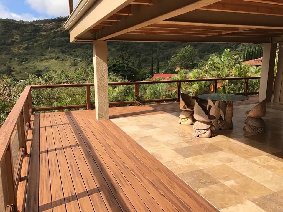 Inspiration for a large tropical backyard deck in Hawaii with a roof extension.