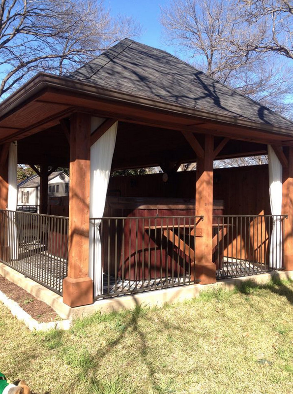 Mid-sized traditional backyard patio in Dallas with a gazebo/cabana and natural stone pavers.