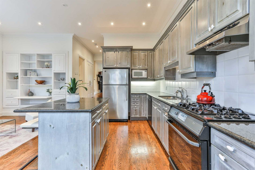 Example of a transitional kitchen design in Toronto