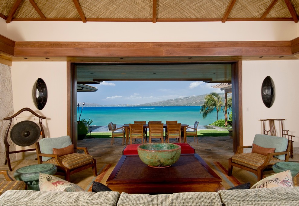 Photo of a mid-sized tropical open concept living room in Hawaii with white walls and no fireplace.