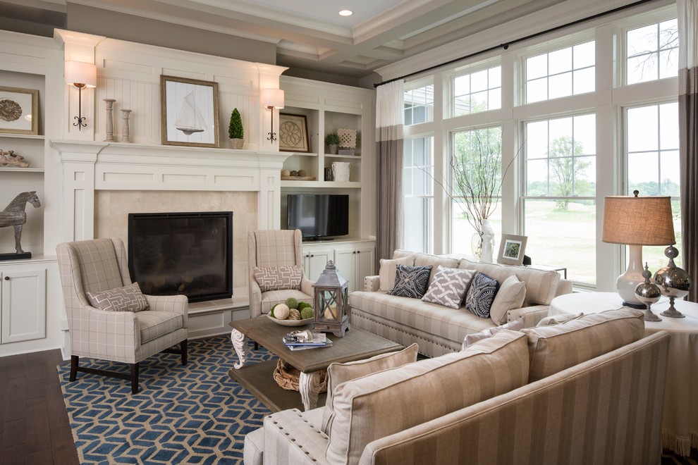 Traditional formal living room in Indianapolis with grey walls, dark hardwood floors, a standard fireplace, a tile fireplace surround and a freestanding tv.