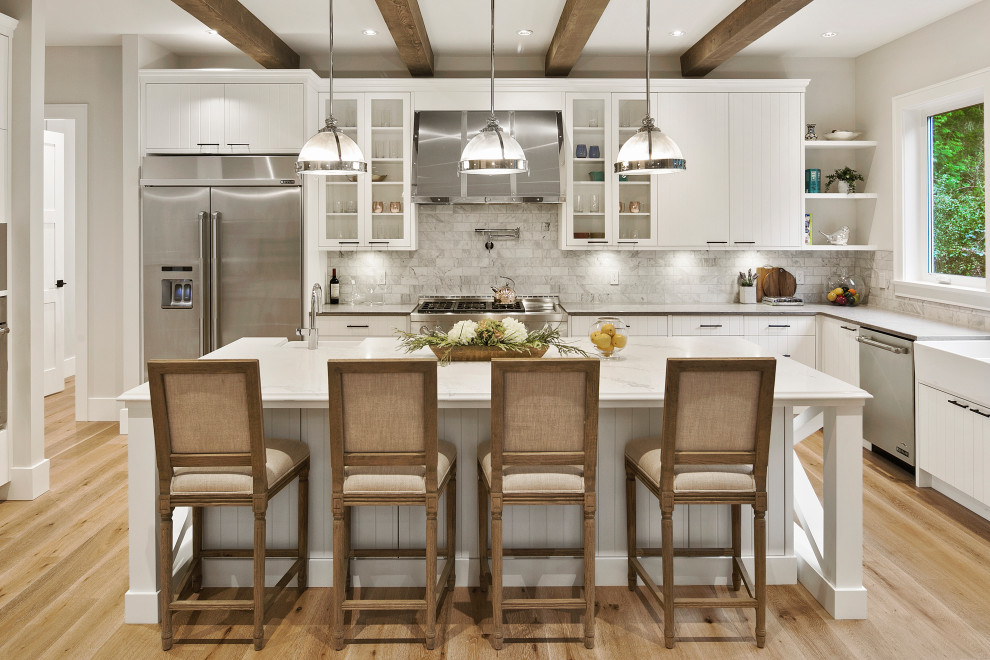 Inspiration for a mid-sized transitional l-shaped light wood floor and beige floor eat-in kitchen remodel with a farmhouse sink, flat-panel cabinets, white cabinets, marble countertops, gray backsplash, marble backsplash, stainless steel appliances, an island and gray countertops