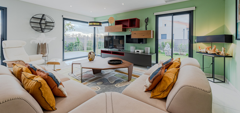 Photo of a large modern open plan games room in Toulouse with green walls, ceramic flooring, no fireplace, a freestanding tv, beige floors and wallpapered walls.
