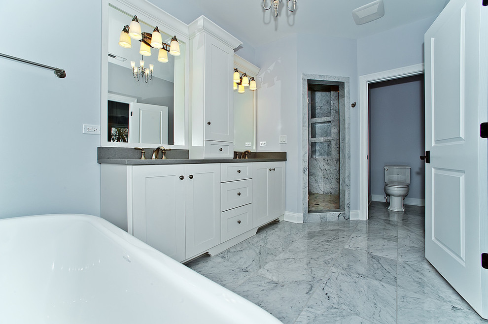 Inspiration for a mid-sized transitional master marble floor and gray floor freestanding bathtub remodel in Chicago with shaker cabinets, white cabinets, gray walls, an undermount sink, soapstone countertops and gray countertops