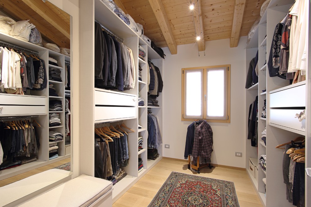 Photo of a contemporary men's walk-in wardrobe in Venice with white cabinets, light hardwood floors, beige floor and open cabinets.