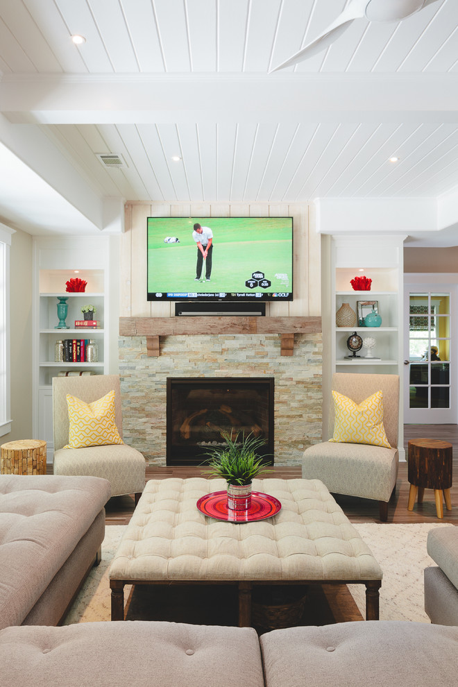 This is an example of a large beach style formal open concept living room in Atlanta with beige walls, porcelain floors, a stone fireplace surround, a standard fireplace and a wall-mounted tv.