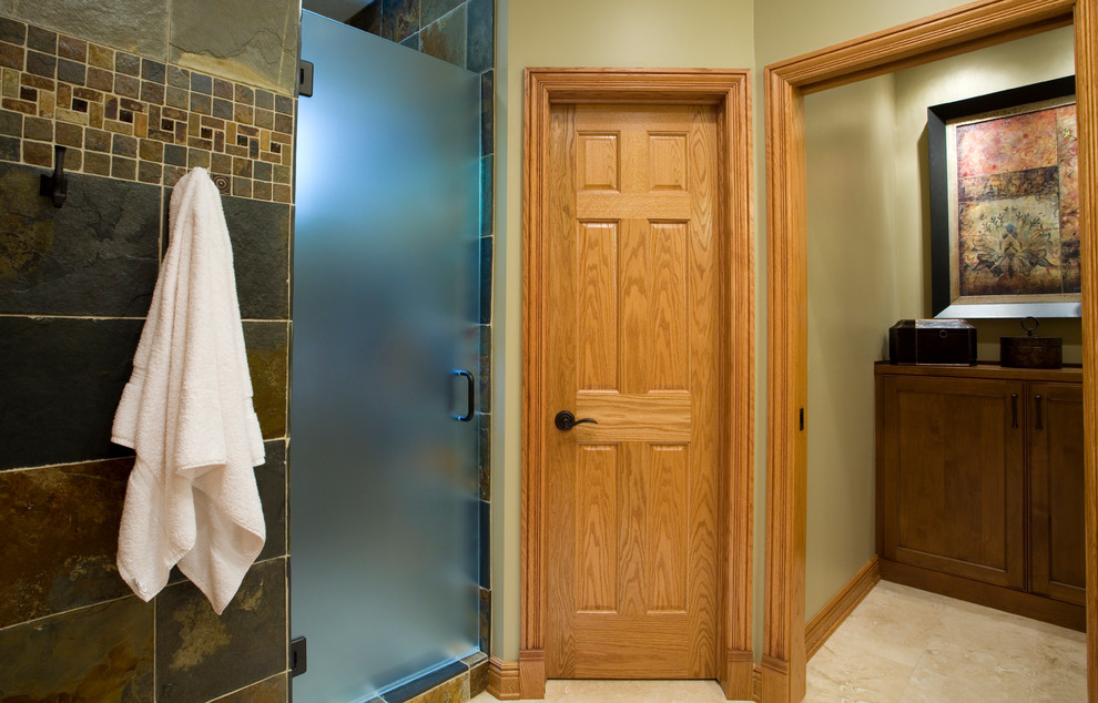 Inspiration for a mid-sized traditional master bathroom in Other with recessed-panel cabinets, medium wood cabinets, an alcove shower, brown tile, beige walls, a hinged shower door and red benchtops.