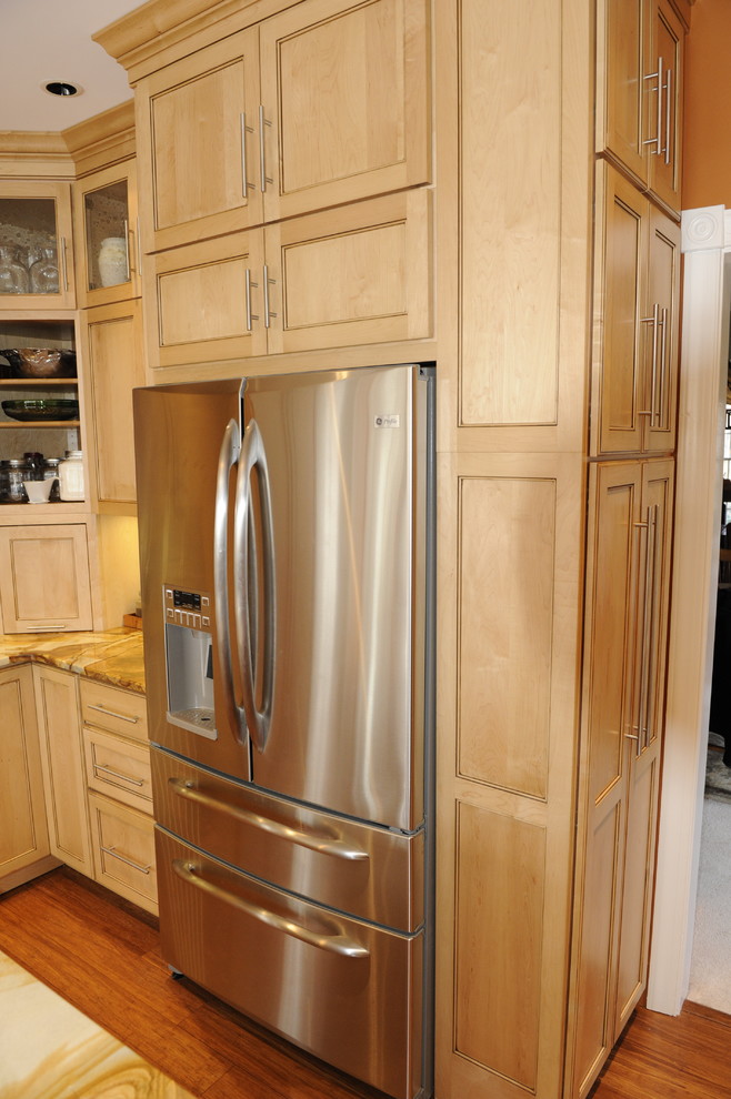 Eat-in kitchen - mid-sized transitional u-shaped light wood floor eat-in kitchen idea in Baltimore with a farmhouse sink, beaded inset cabinets, light wood cabinets, onyx countertops, stainless steel appliances and an island