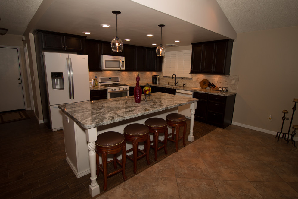 Mid-sized transitional l-shaped porcelain tile open concept kitchen photo with an undermount sink, flat-panel cabinets, dark wood cabinets, quartz countertops, beige backsplash, glass sheet backsplash, white appliances and an island