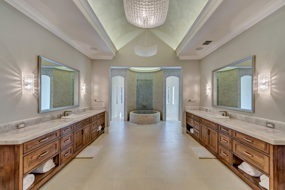 Inspiration for a huge transitional master white tile and stone tile limestone floor and white floor freestanding bathtub remodel in Orange County with shaker cabinets, dark wood cabinets, a one-piece toilet, gray walls, a drop-in sink and quartzite countertops