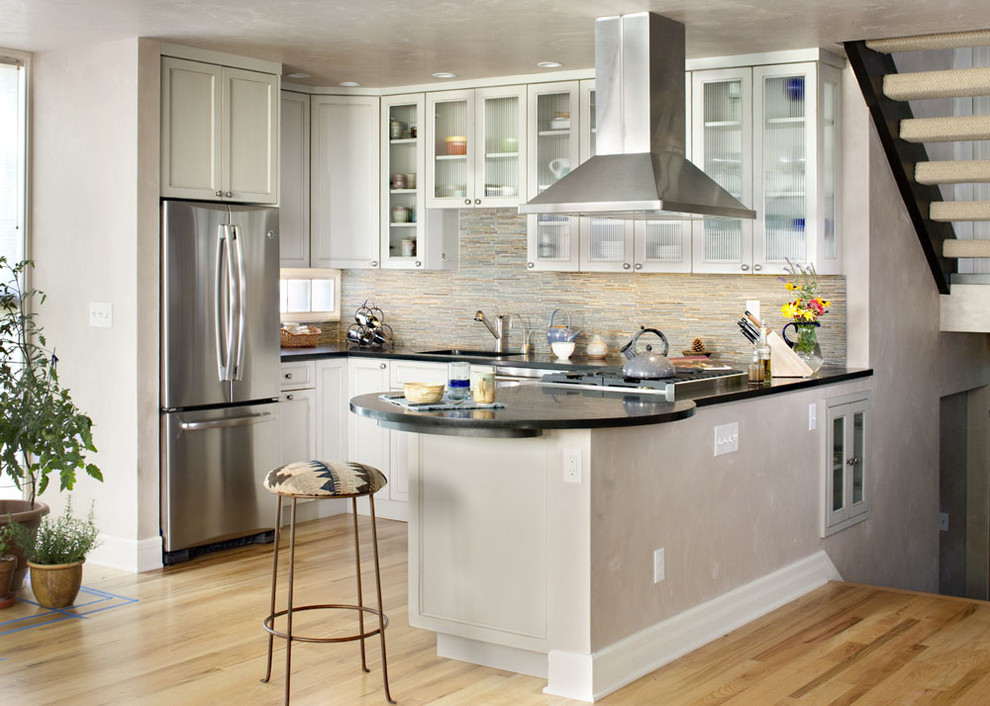 Mid-sized transitional u-shaped light wood floor open concept kitchen photo in Denver with an undermount sink, recessed-panel cabinets, gray cabinets, granite countertops, multicolored backsplash, mosaic tile backsplash, stainless steel appliances and a peninsula