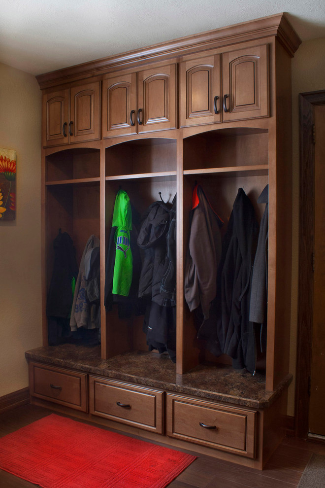 Example of a mid-sized transitional dark wood floor mudroom design with beige walls