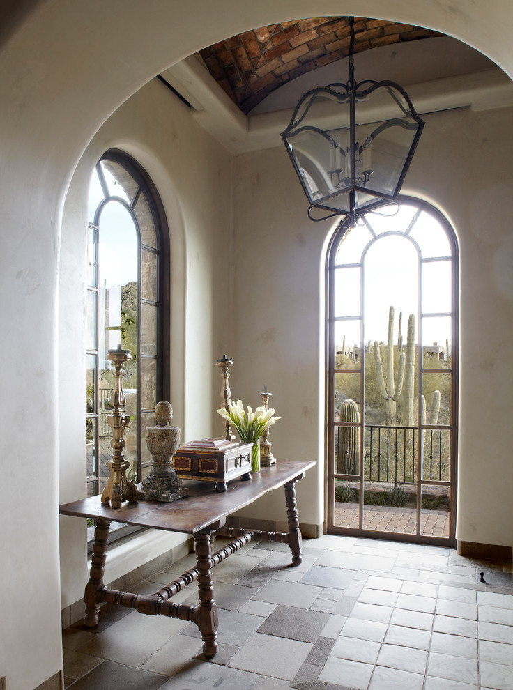 Inspiration for a mid-sized mediterranean entry hall in Phoenix with beige walls.
