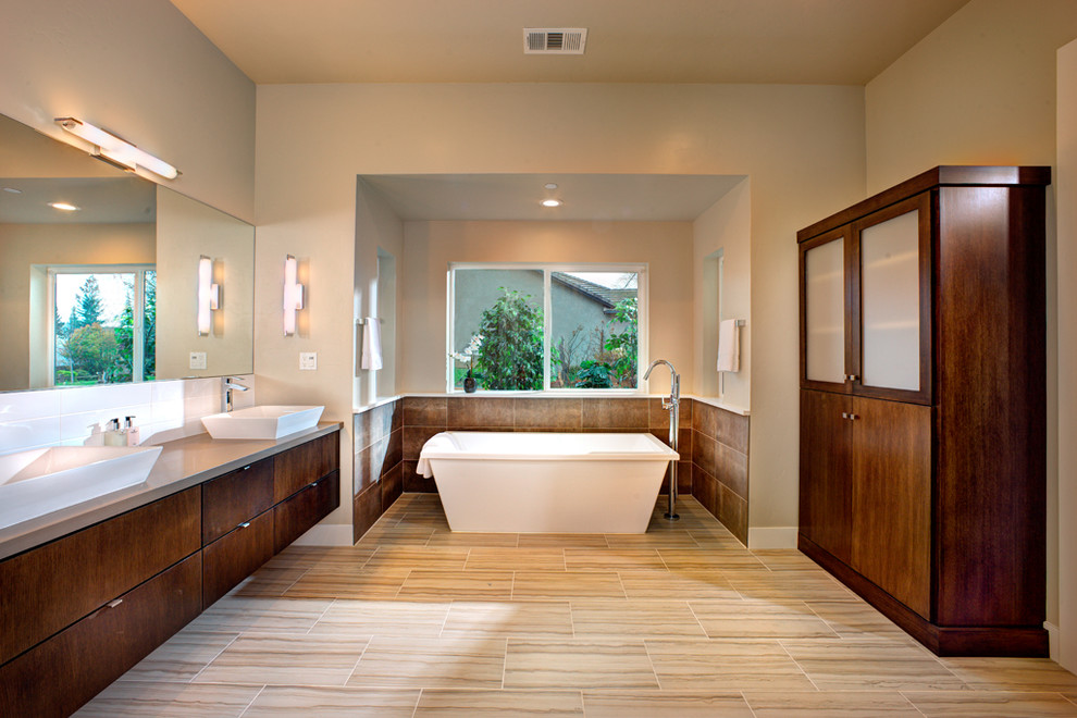 Inspiration for a mid-sized contemporary master bathroom in Sacramento with flat-panel cabinets, medium wood cabinets, a freestanding tub, brown tile, porcelain tile, beige walls, porcelain floors, a vessel sink, engineered quartz benchtops and beige floor.