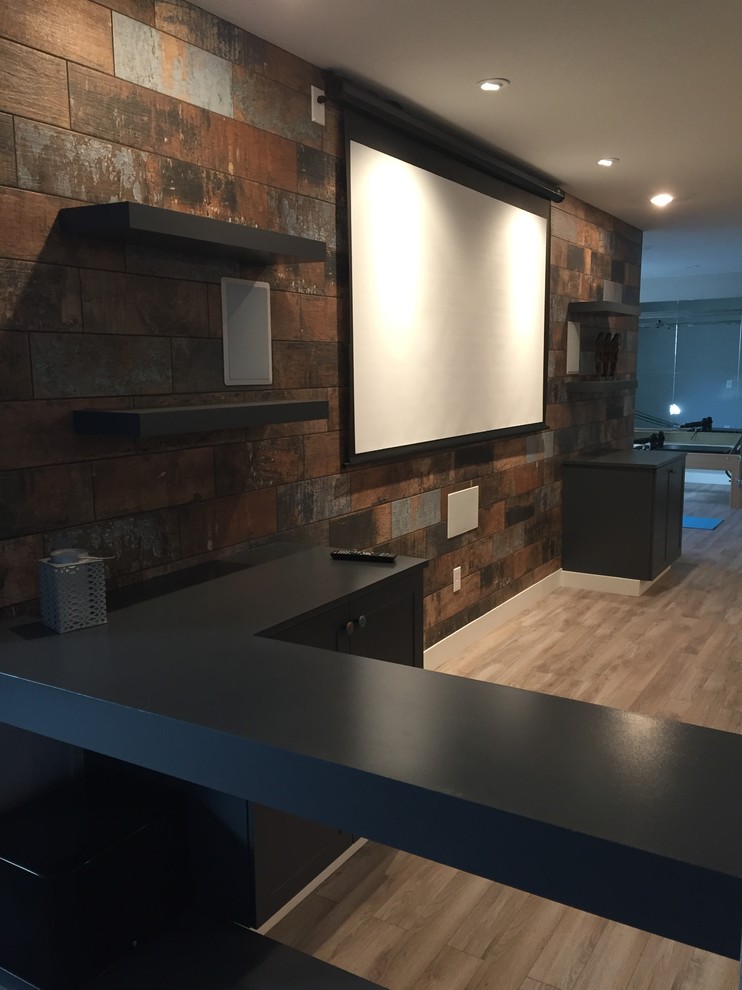 Photo of a large transitional open concept home theatre in Denver with a projector screen, multi-coloured walls, medium hardwood floors and brown floor.